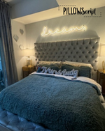 Load image into Gallery viewer, Neon sign above a bed with decorative pillows and blankets, featuring the brand 'PILLOWScript'.
